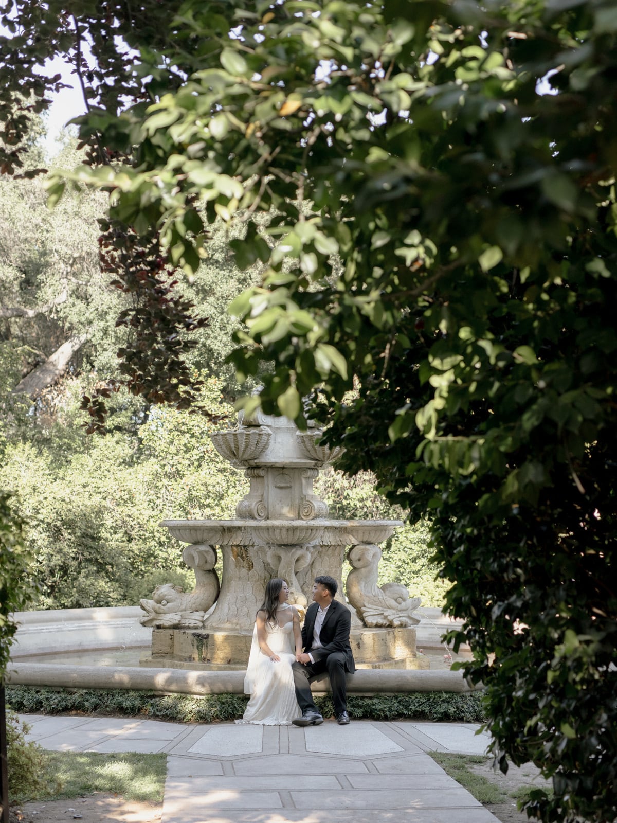 Edwin and Grace sitting near a garden fountain