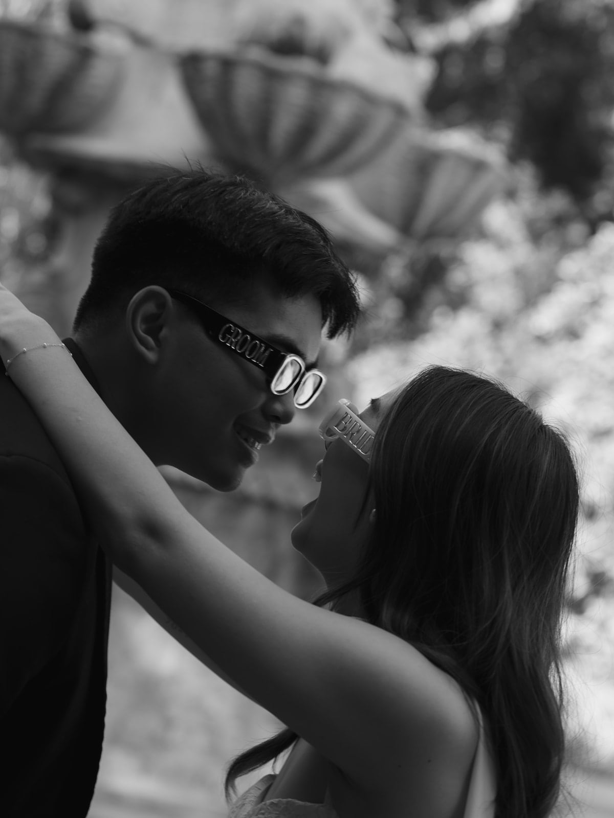 Edwin and Grace wearing bridal glasses in a black and white engagement photo