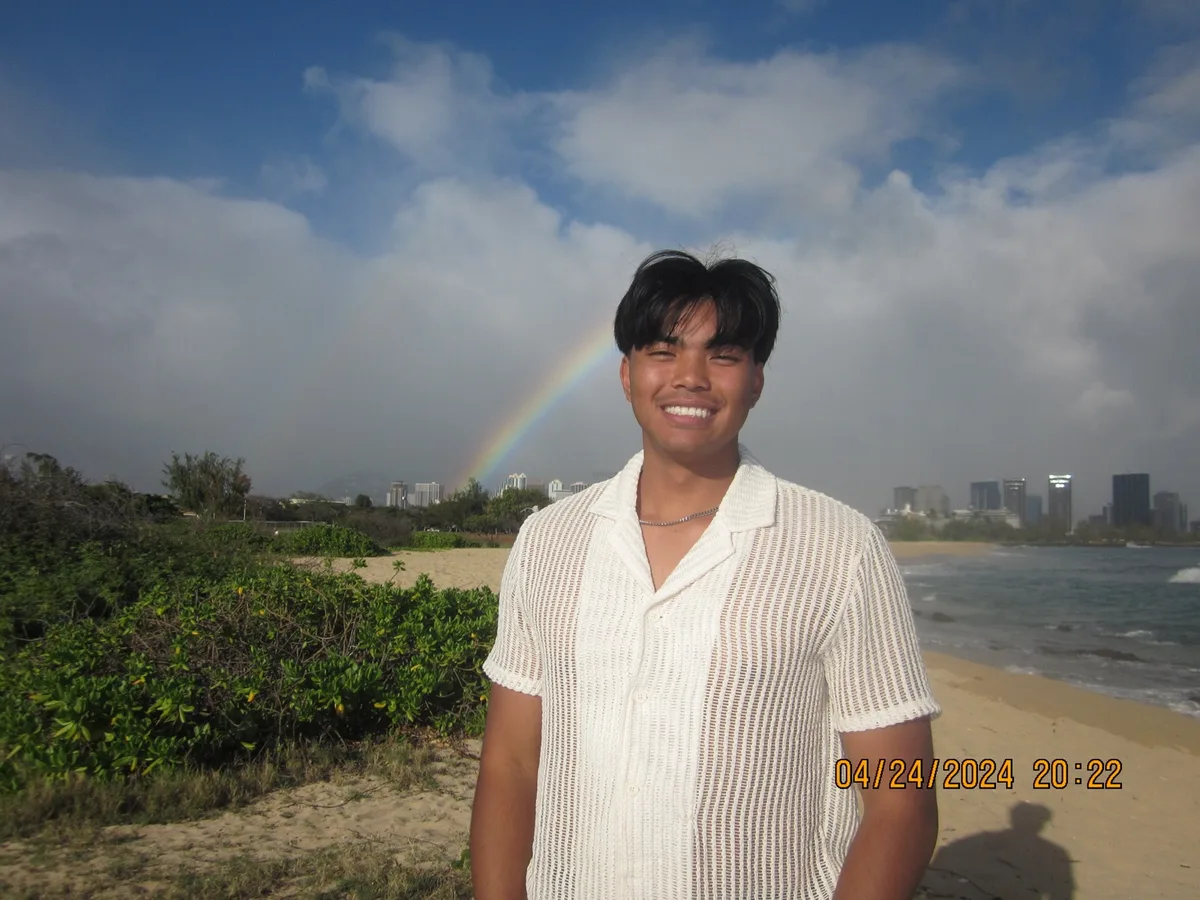 Edwin standing beneath the rainbow on the day he proposed to Grace