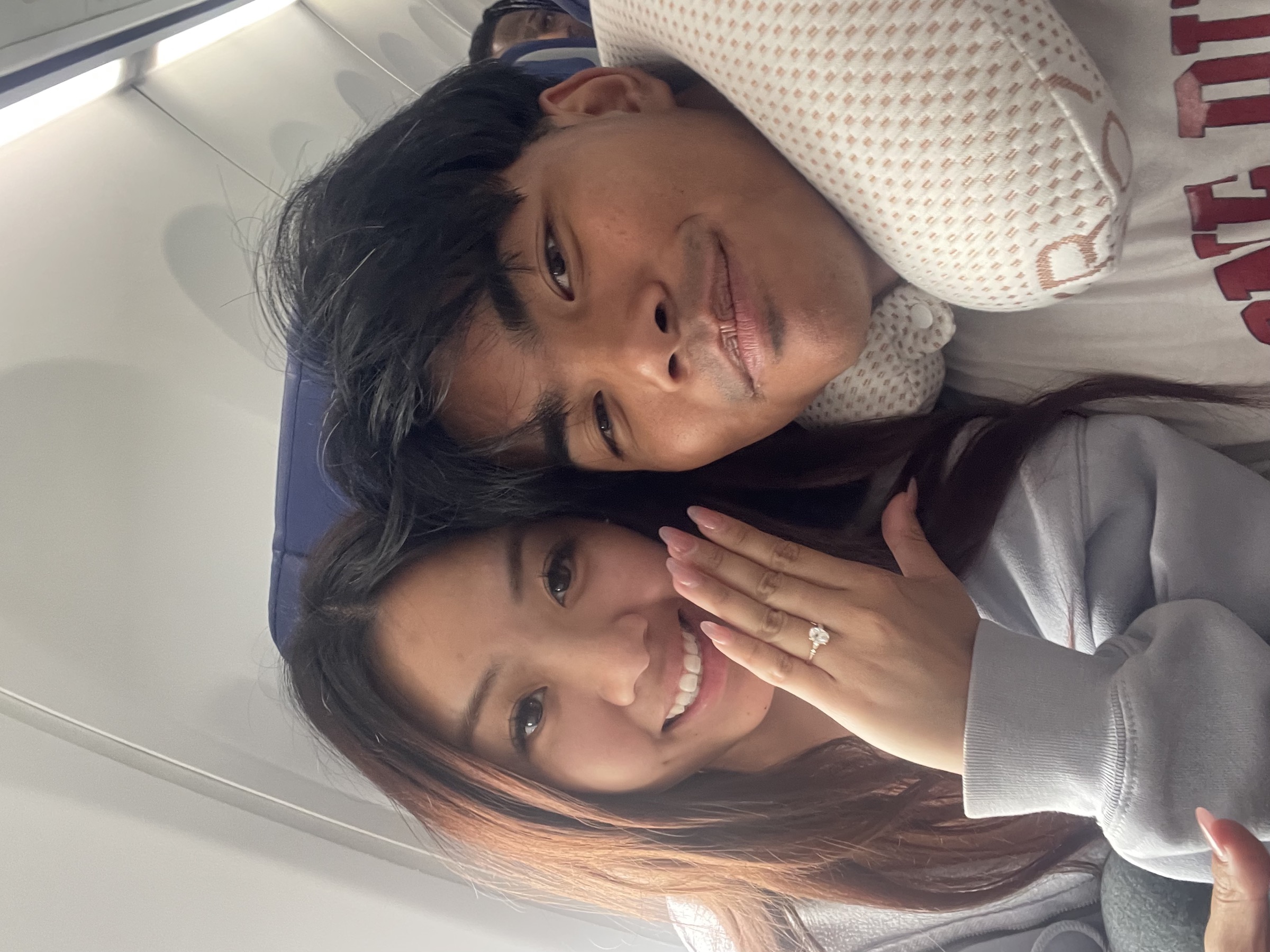 Edwin and Grace on the plane ride home from Hawaii after the proposal
